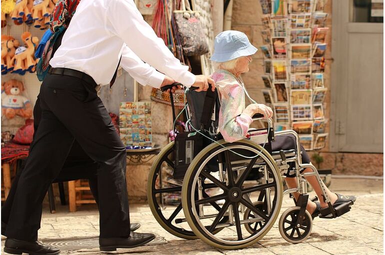 elderly-woman-sick-care-man-wheel-chair